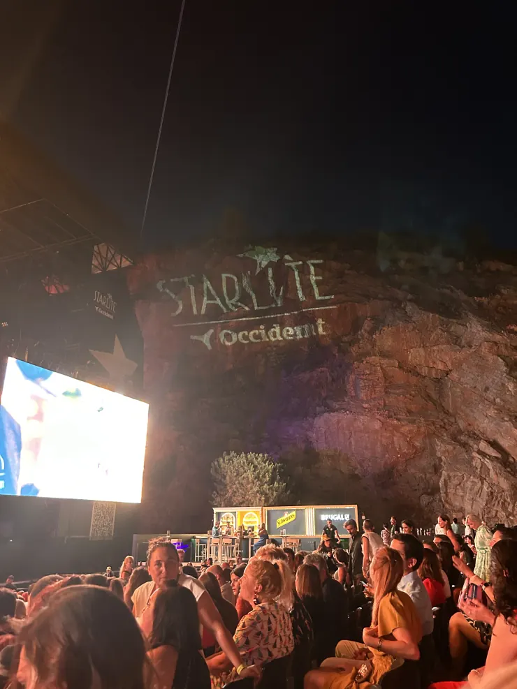 The Starlite stage built into a floodlit rock face, crowd gathered below