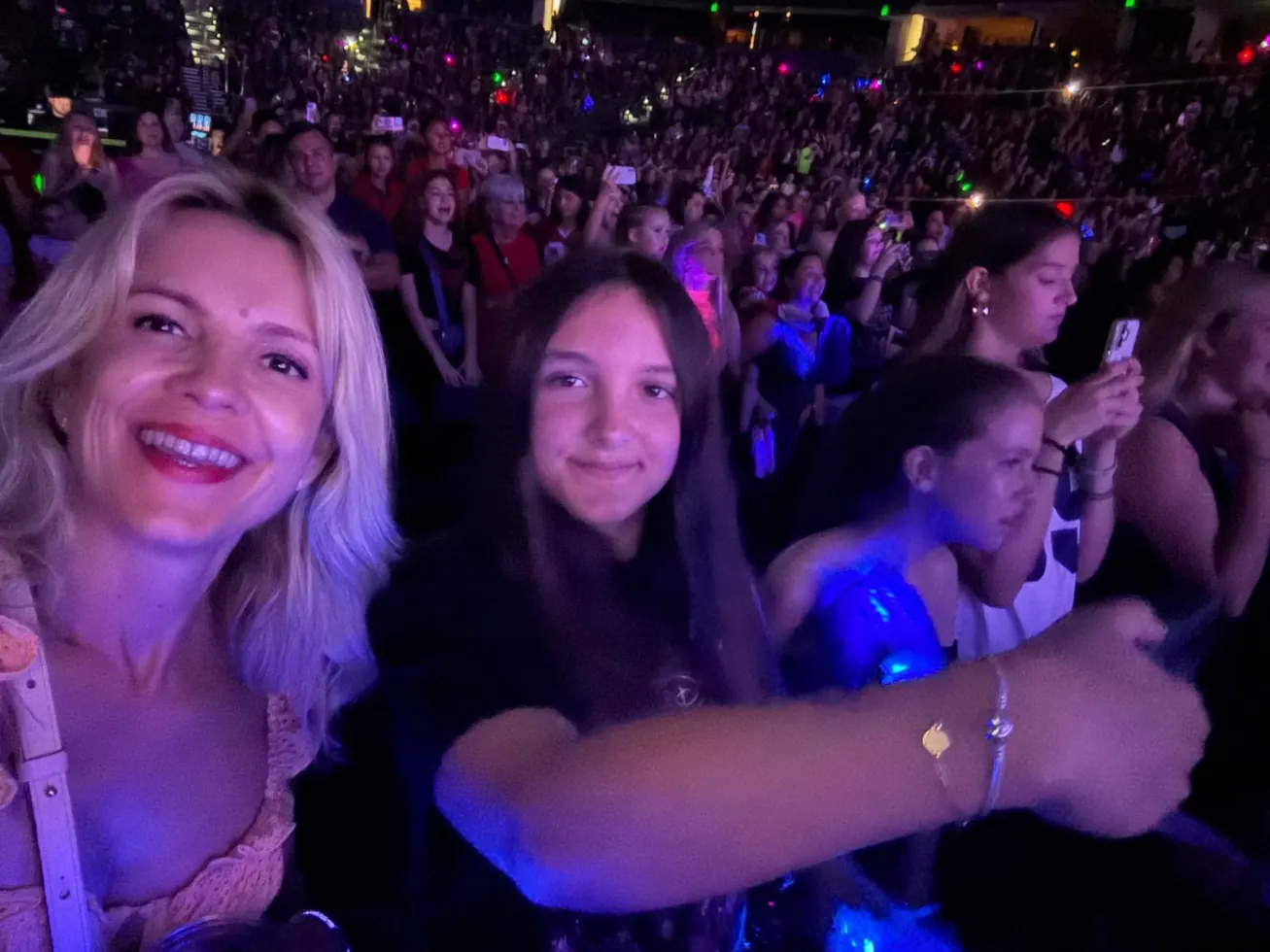 Ruby and her mum smiling in the middle of the crowd