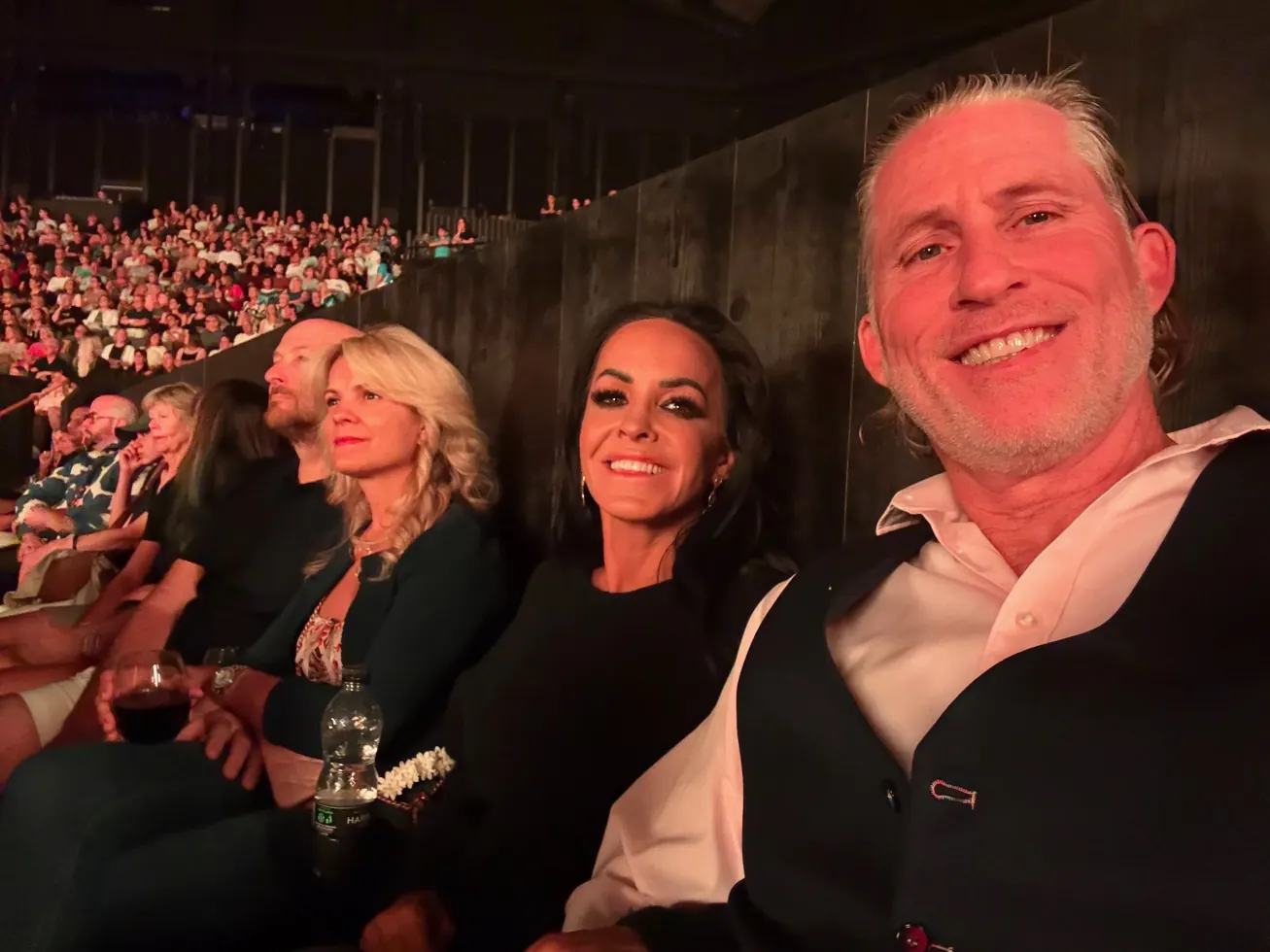 Ruby and family smiling from their seats in the arena