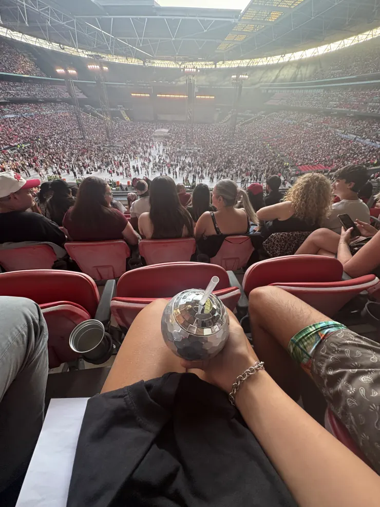Looking down the row of red seats with a drink in hand before the show