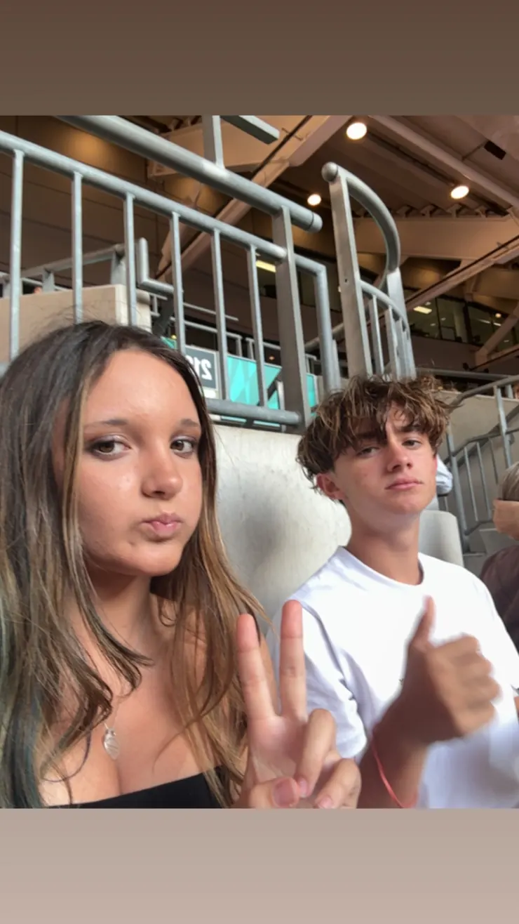Ruby and a friend pulling faces for the camera in the stands