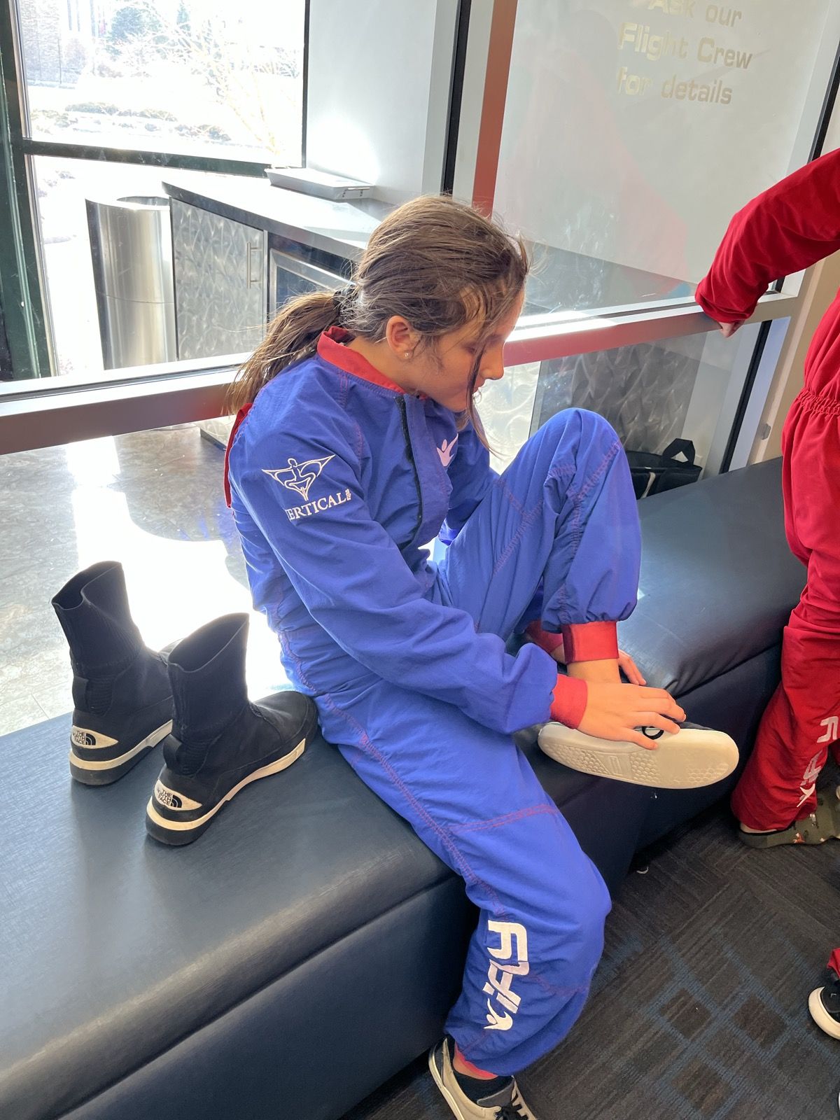 Ruby in a blue flight suit at the Denver wind tunnel