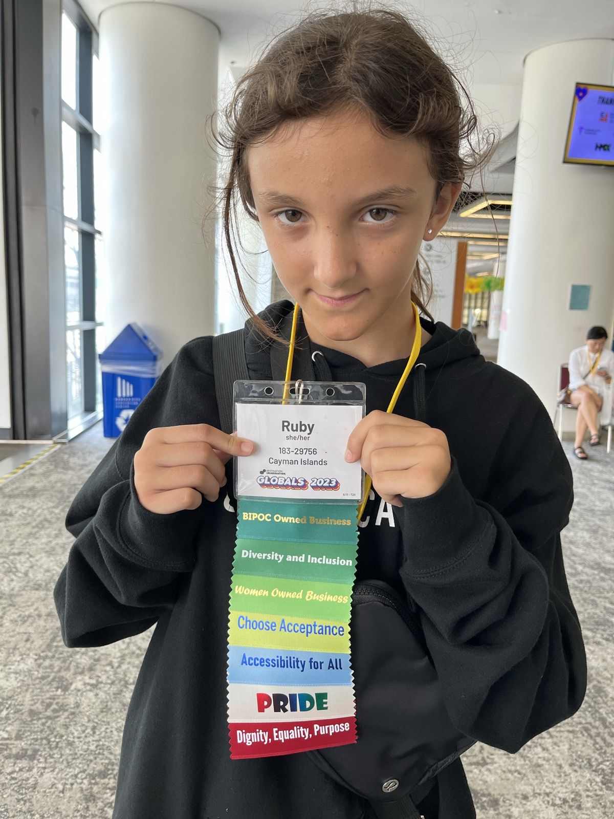 Ruby holding up her event badge