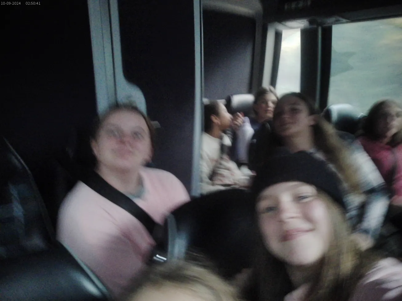 Campers dozing against each other on a night bus