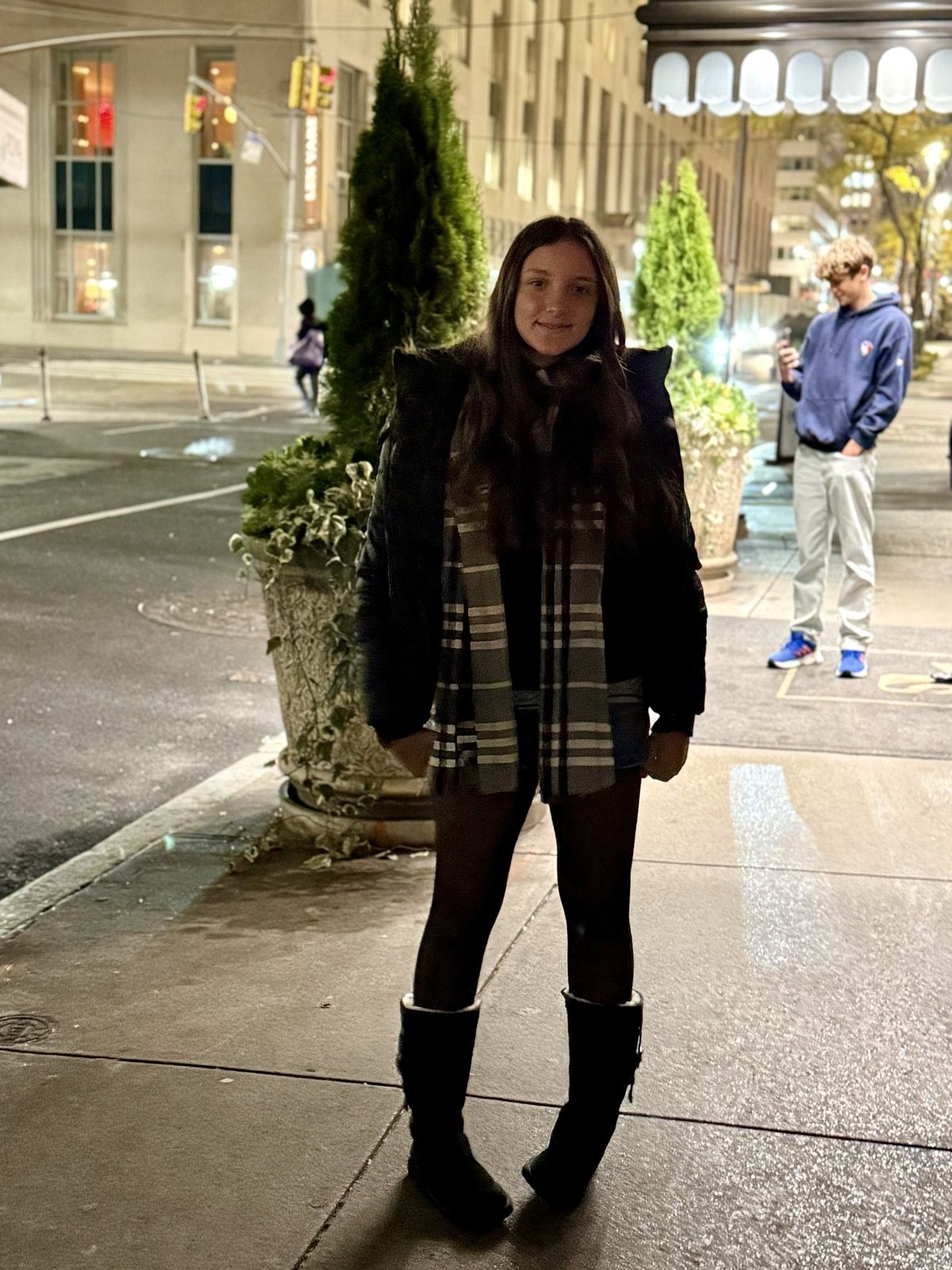Ruby in a plaid coat on a New York street at night