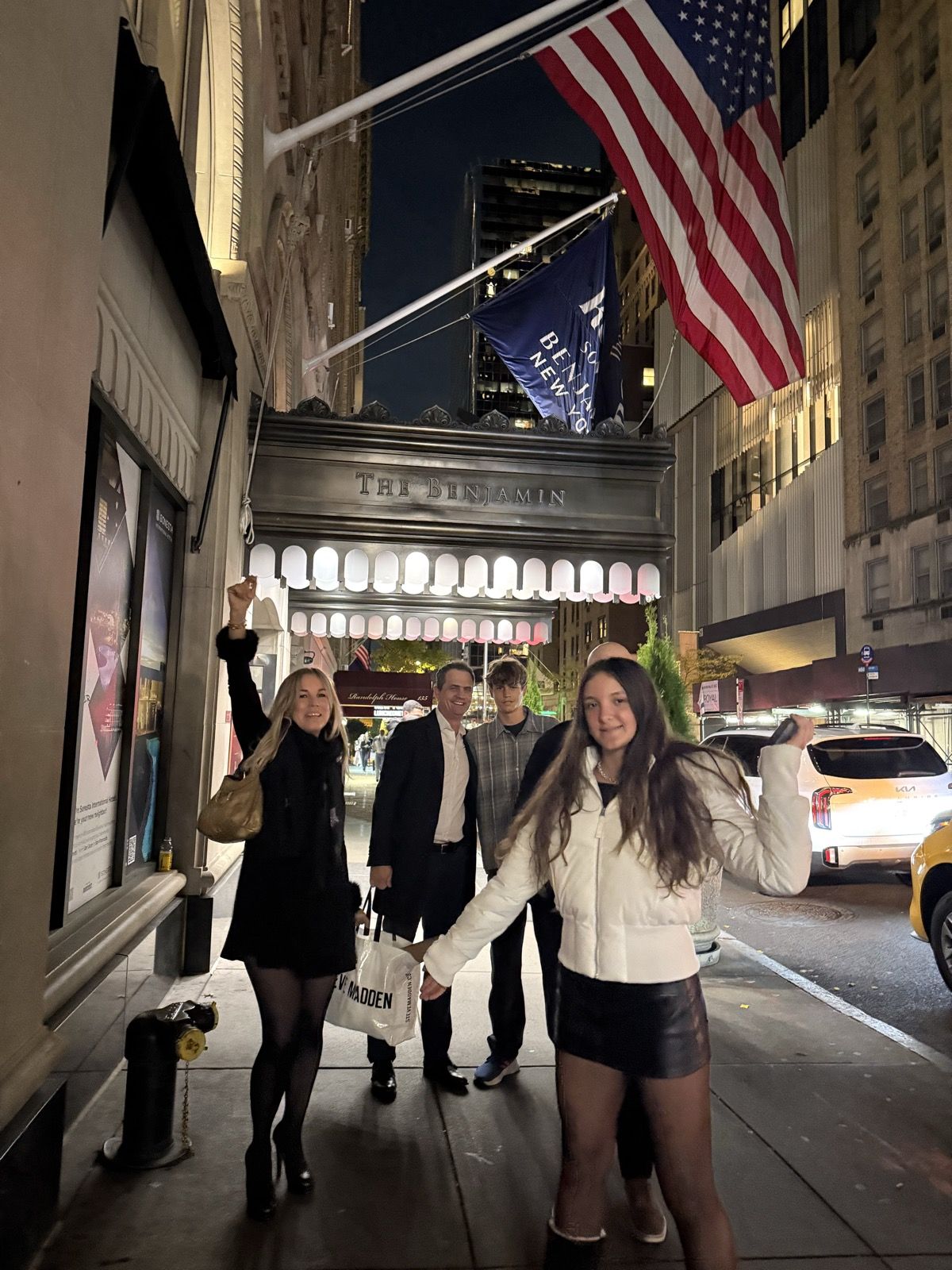 Night street with a flag over a gilded entrance