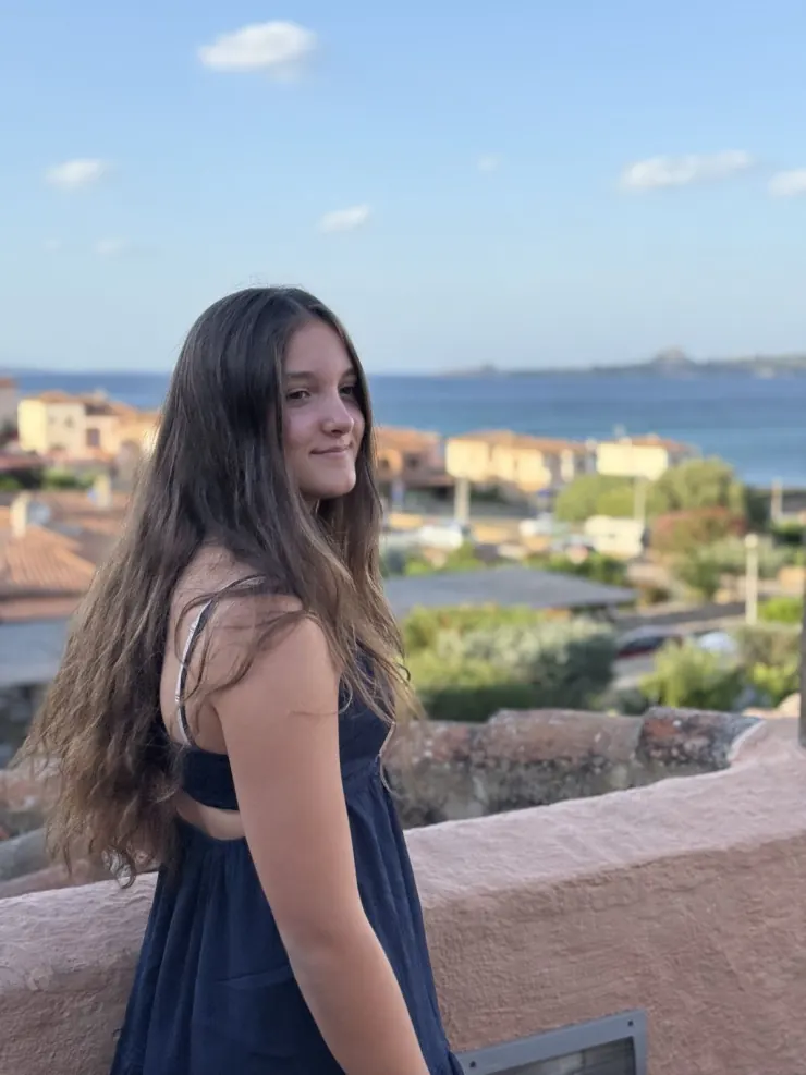 Ruby in a navy dress above the harbour