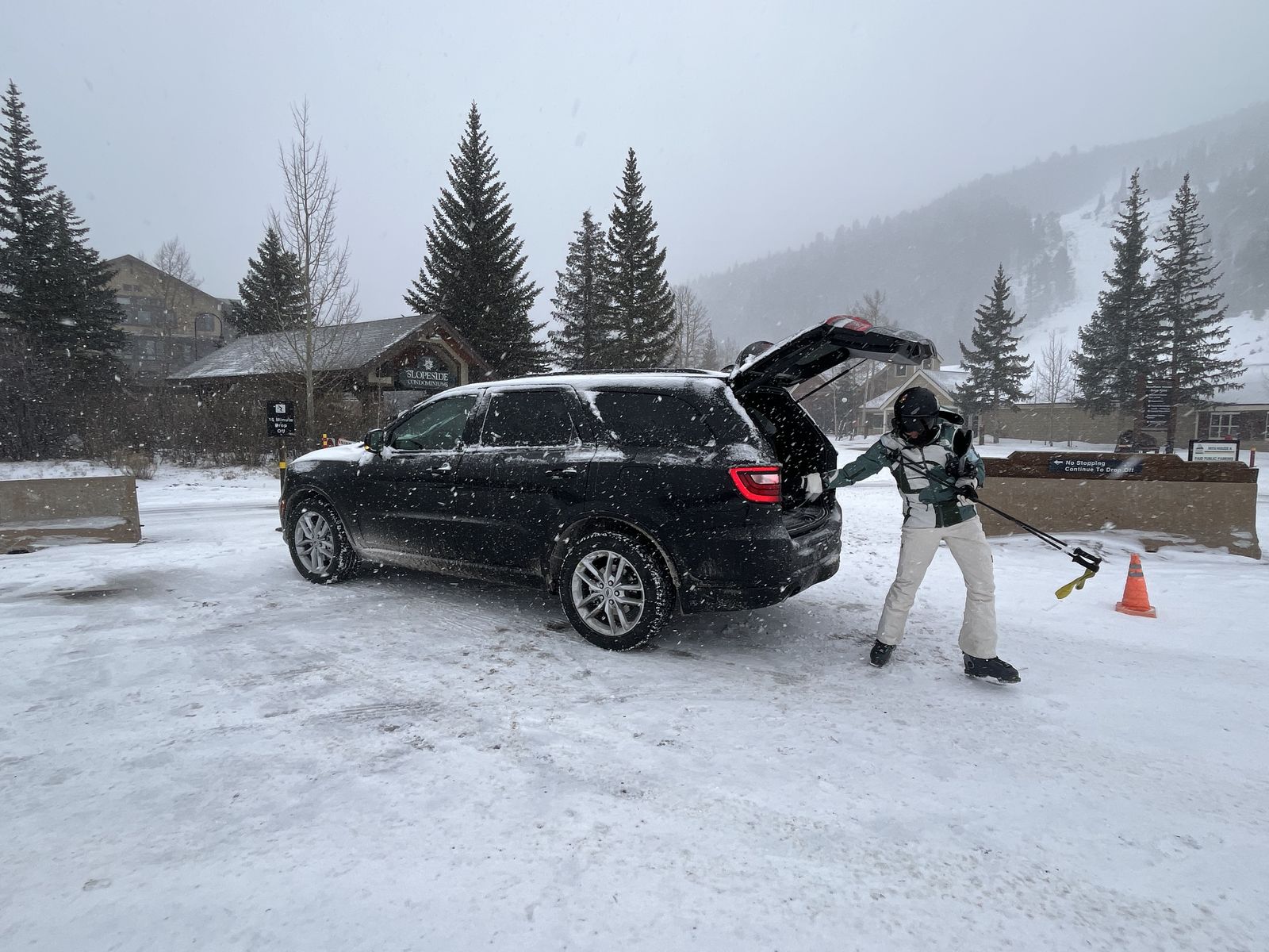 Loading skis into the car boot at Keystone in falling snow