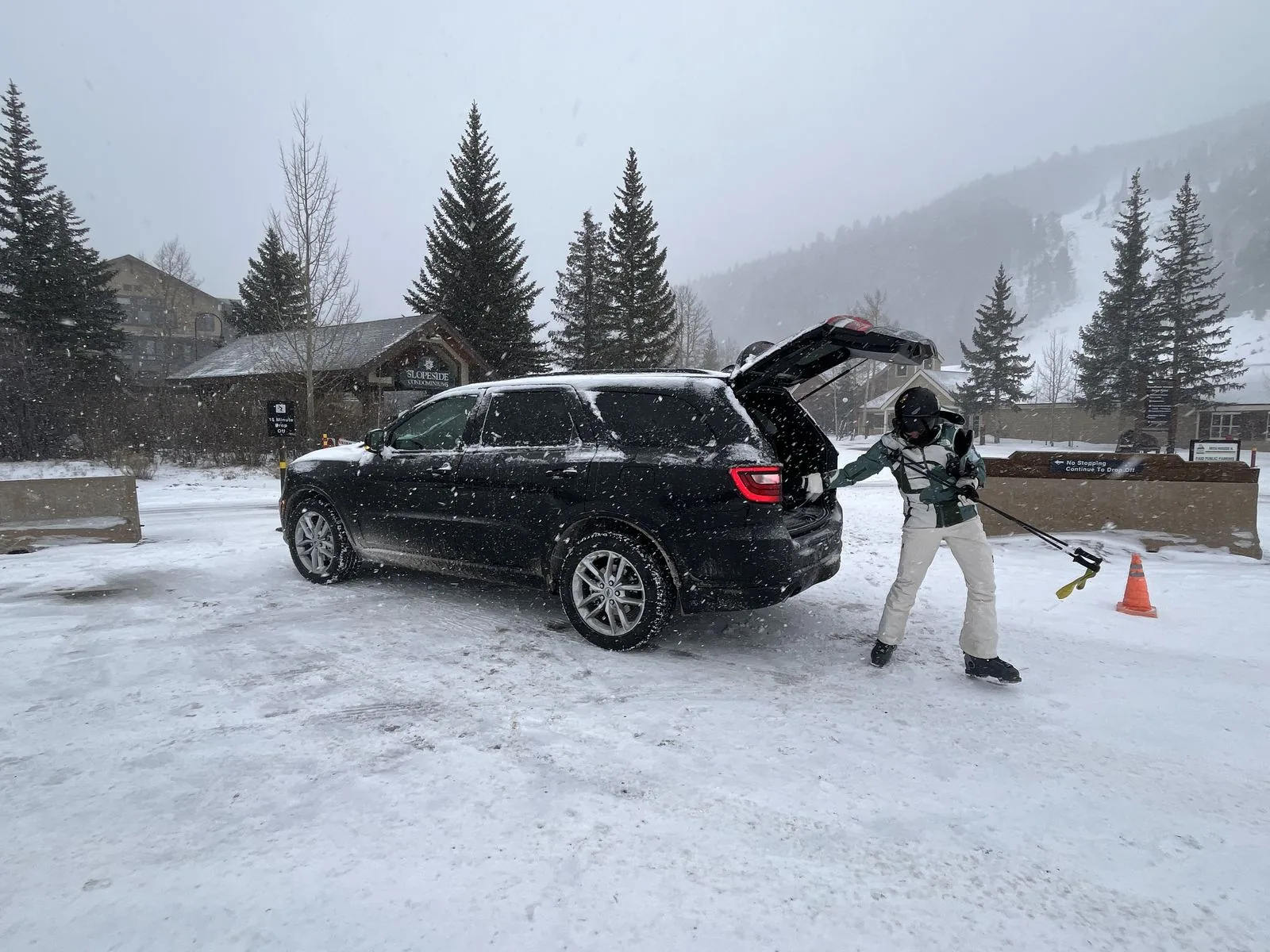 Loading skis into the car boot at Keystone in falling snow