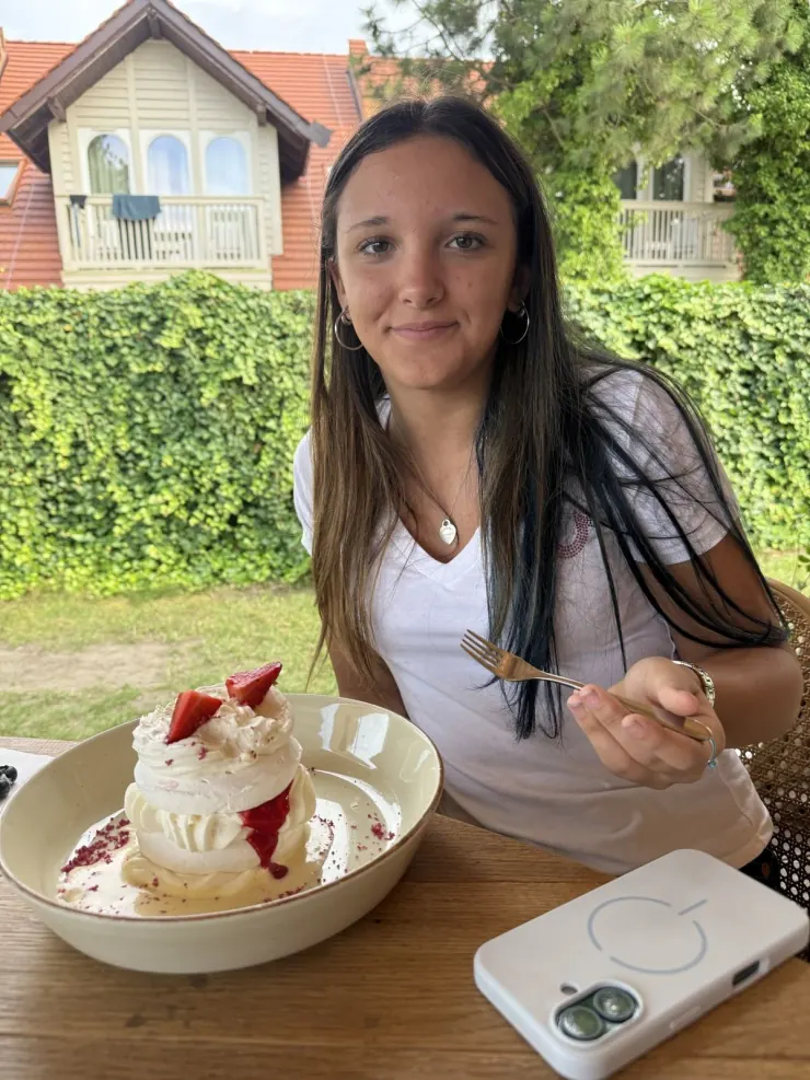 Ruby with a strawberry sundae at a garden table