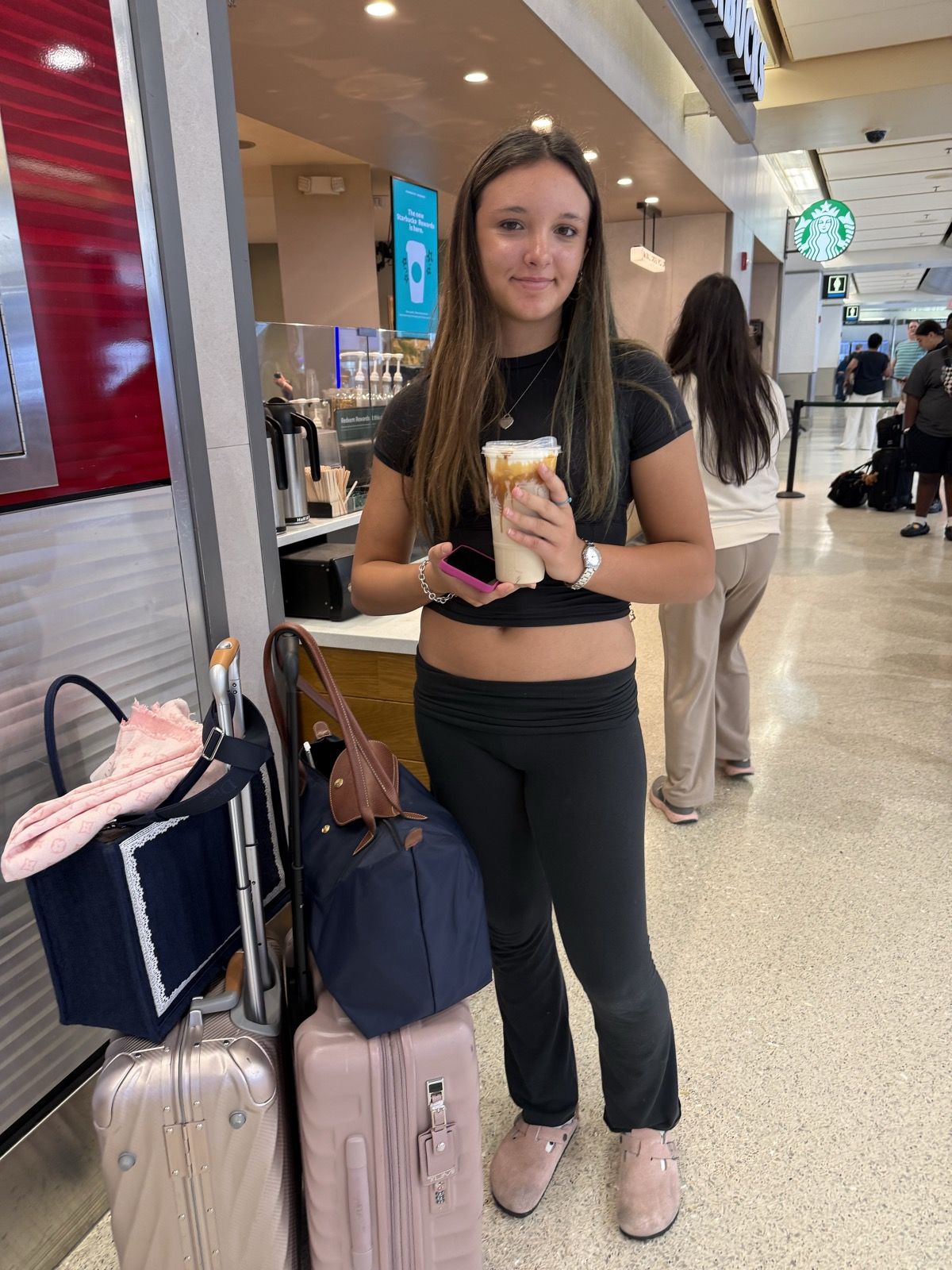 Ruby with luggage at the airport, heading home
