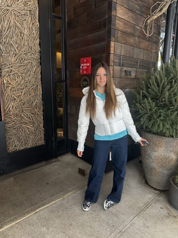 Ruby in a white puffer jacket in a doorway
