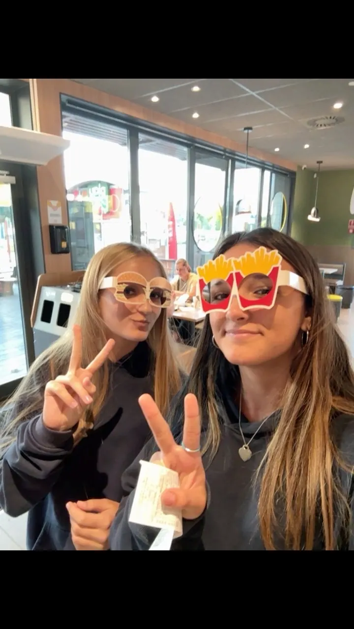 Ruby and a friend wearing novelty fast-food-shaped glasses